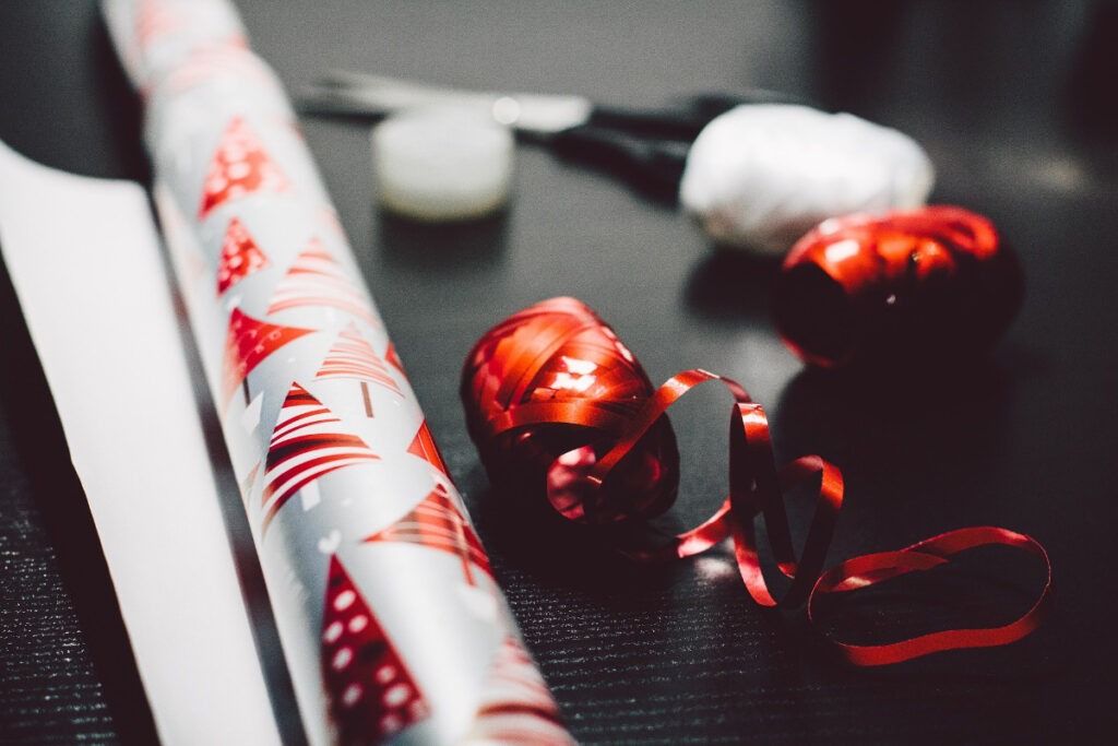 gift wrapping paper, scissors, and ribbon